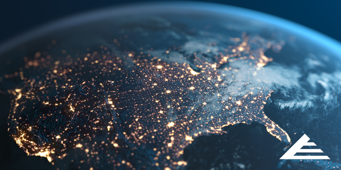 Satellite view of the United States at night with illuminated cities representing nationwide supply and distribution networks.